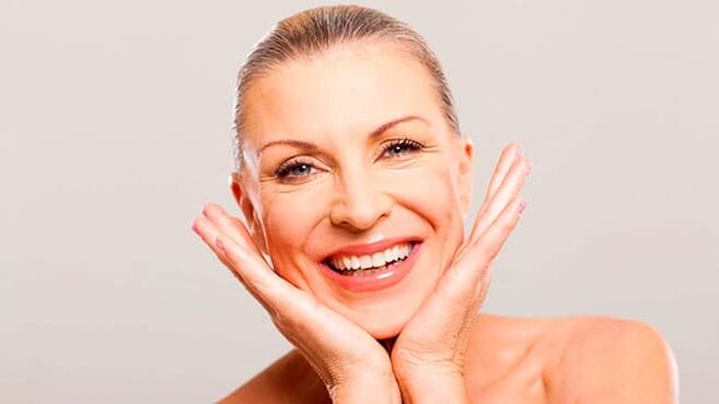 Happy woman in her fifties after face skin care